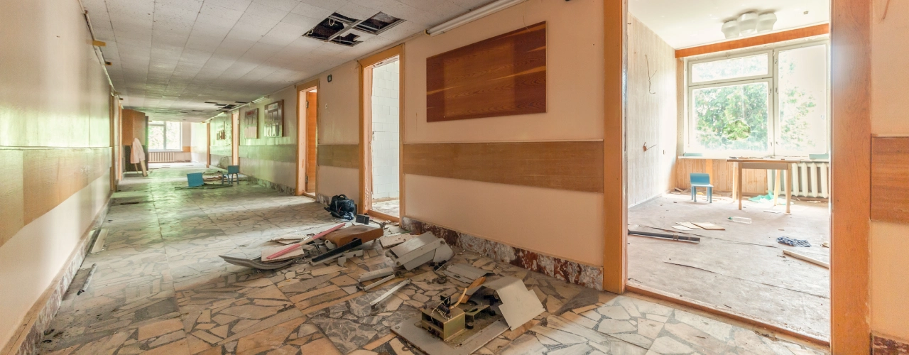 corridor-with-open-doors-in-an-abandoned-building.webp